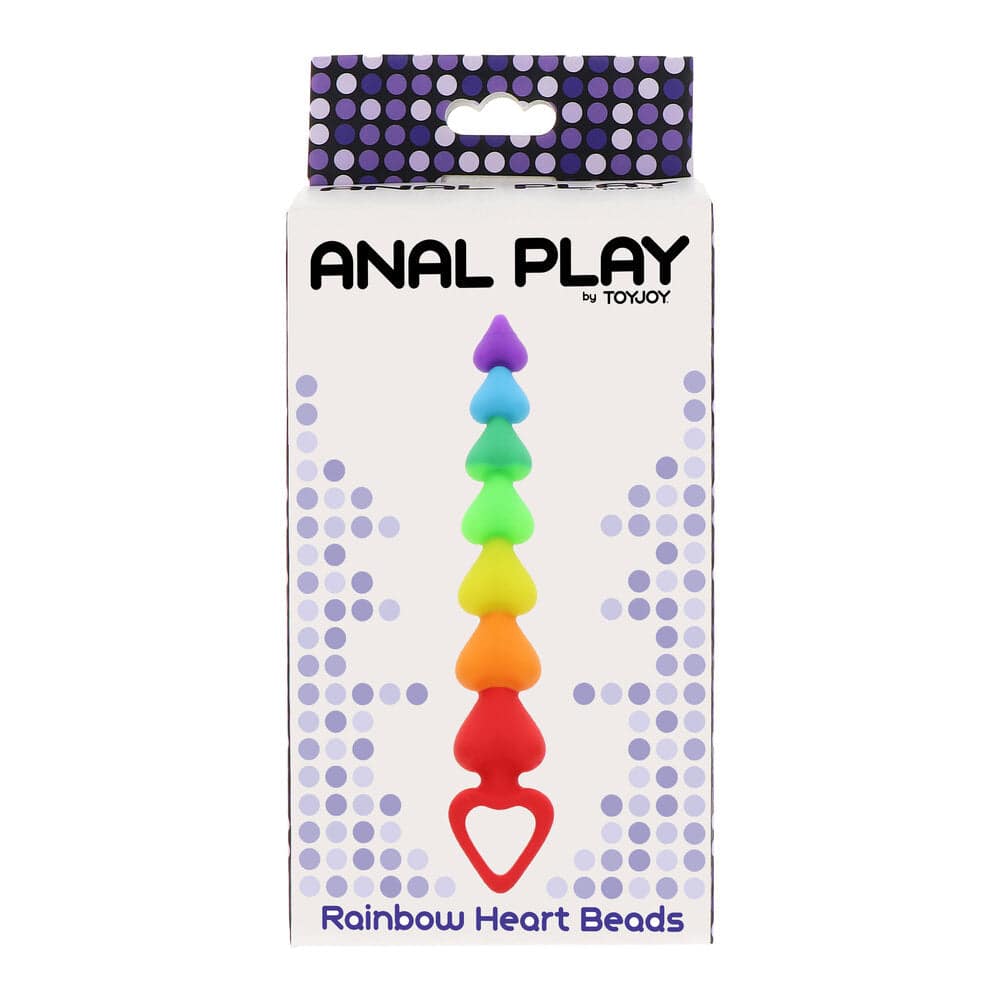 Colorful ToyJoy Regnbågshjärta anal beads arranged in a heart shape on a soft surface, showcasing their vibrant design.
