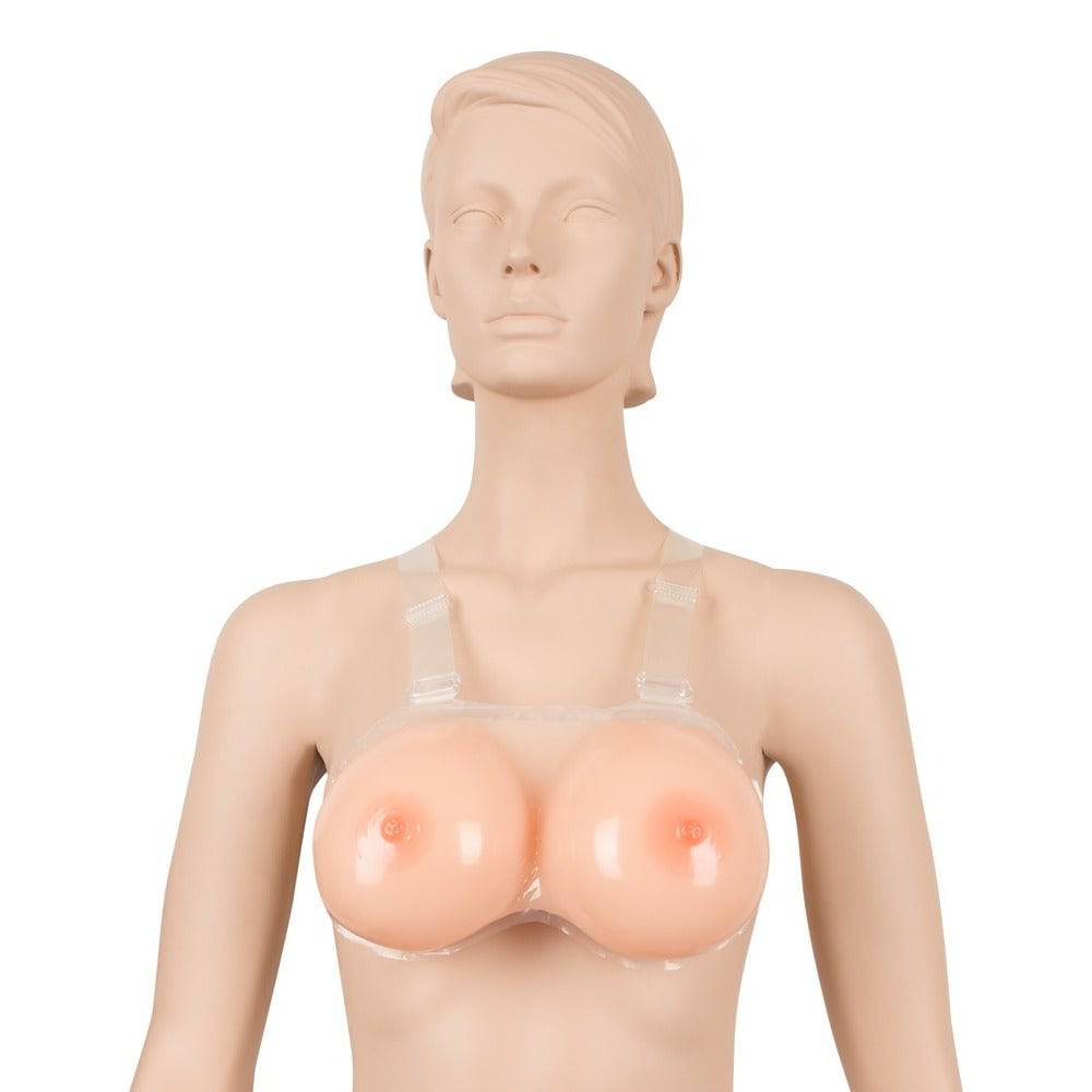 Cottelli Collection 1200g silicone breasts with realistic texture, designed for strap-on use in intimate settings.