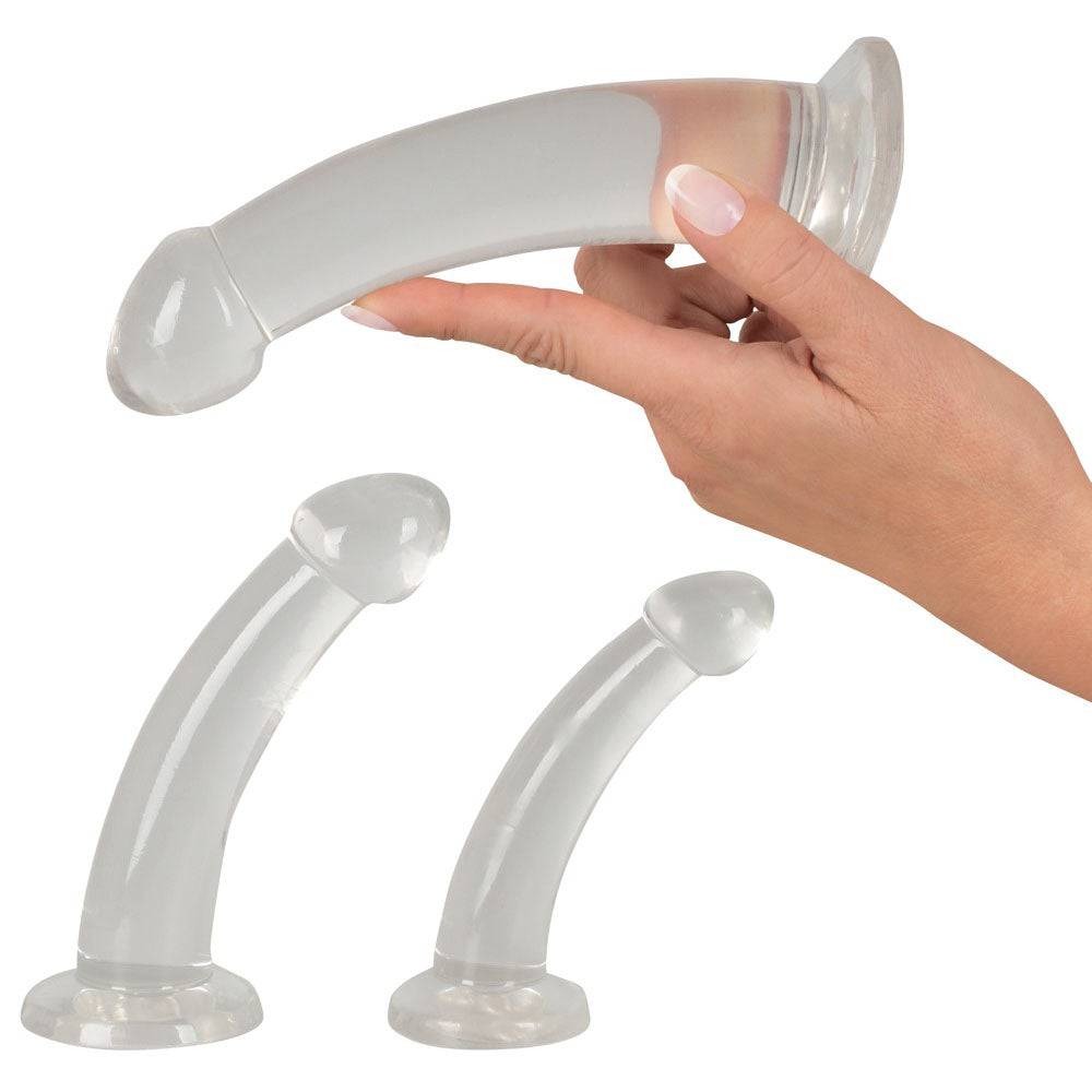 You2Toys Tredelat kristallklart anal träningsset with three different sized silicone plugs on a soft surface.