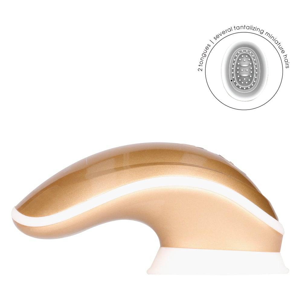 Shots Toys Twitch Gold hands-free vibrating toy with ergonomic design and sleek gold finish on a neutral background.