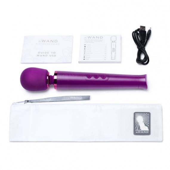 Le Wand Petite rechargeable vibrating massager in dark cherry color with a sleek design and ergonomic handle.