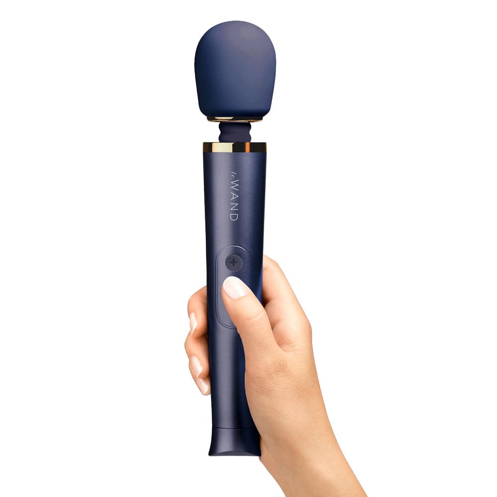 Le Wand Petite rechargeable vibrating massage wand in navy blue with ergonomic design and textured handle.