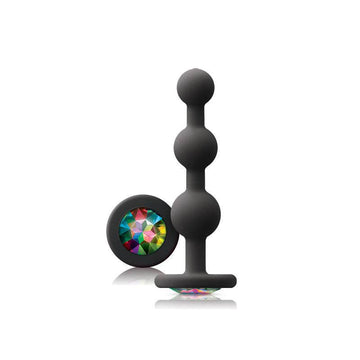 Black ripple anal plug with a rainbow gem by NS Novelties, showcasing a textured design and sparkling detail.