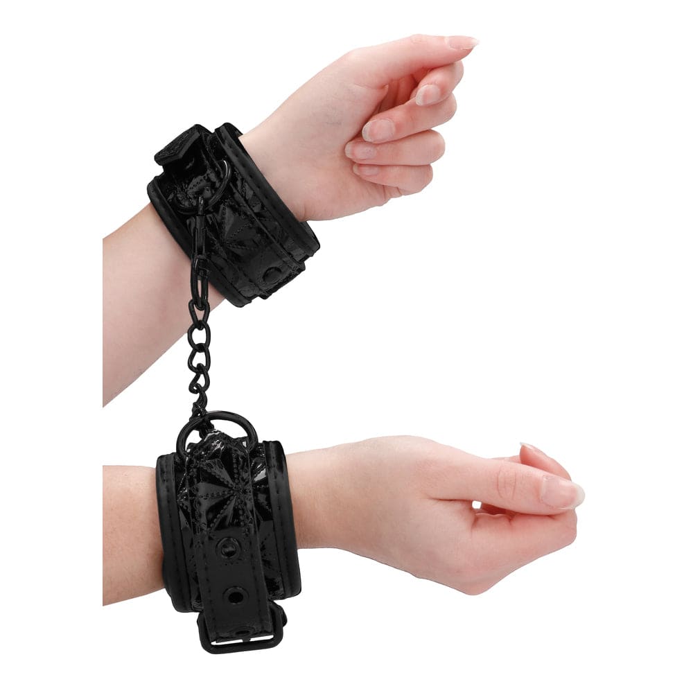Black Ouch Lyxiga handcuffs by Shots Toys, featuring a sleek design and soft padding for comfort.