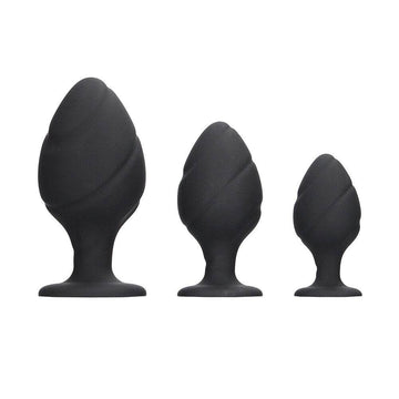 Black silicone swirled butt plug set from Shots Toys, featuring smooth curves and a tapered design for comfort.