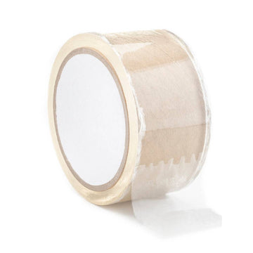 Transparent bondage tape from Shots Toys, coiled on a surface with a smooth texture and clear finish.