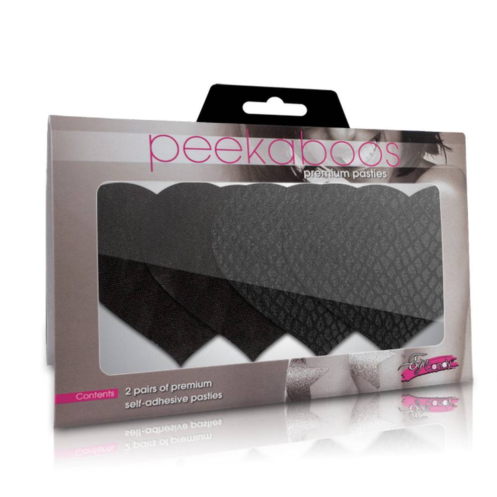 Black heart-shaped Peekaboos pasties on a flat surface, showcasing their smooth finish and unique design.