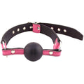 Rouge Garments pink ball gag with adjustable straps and soft finish, designed for comfortable wear in bondage play.
