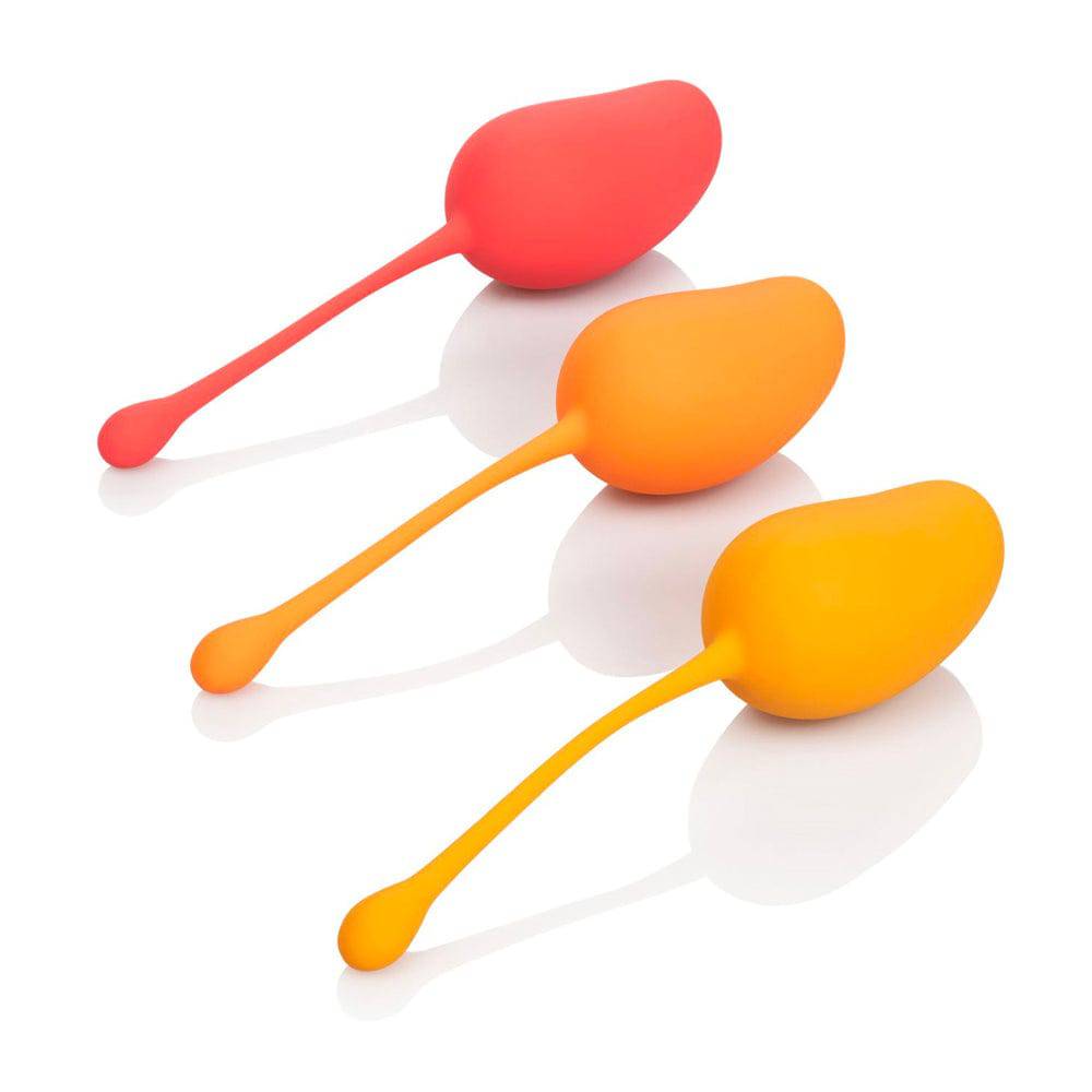 California Exotic Kegel training set in mango color, featuring three smooth, ergonomic weights for pelvic floor exercises.