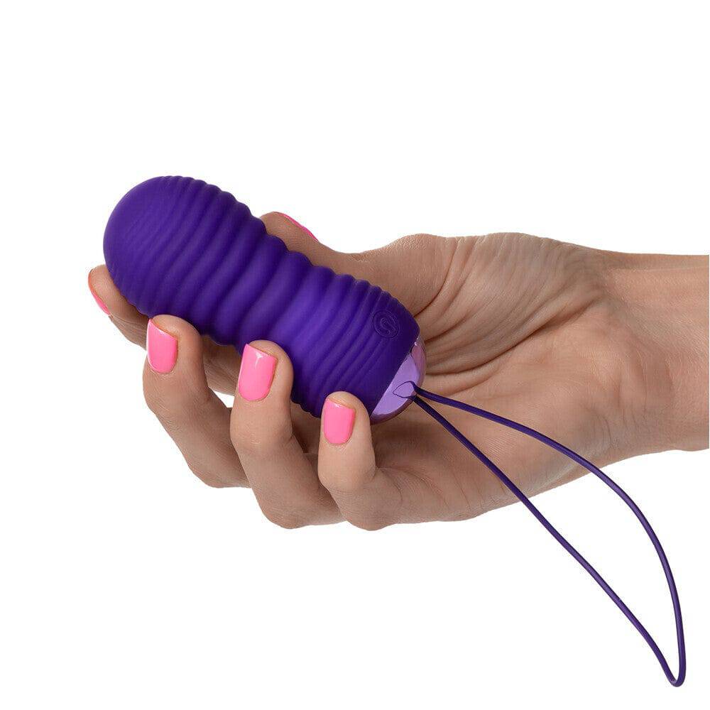 California Exotic Slay THRUSTME ribbed remote control ball in pink with textured surface for enhanced stimulation.