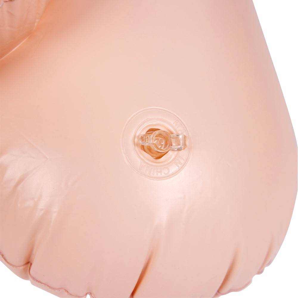 Inflatable 55-inch penis toy by Shots Toys, featuring realistic details and a glossy finish in a playful setting.