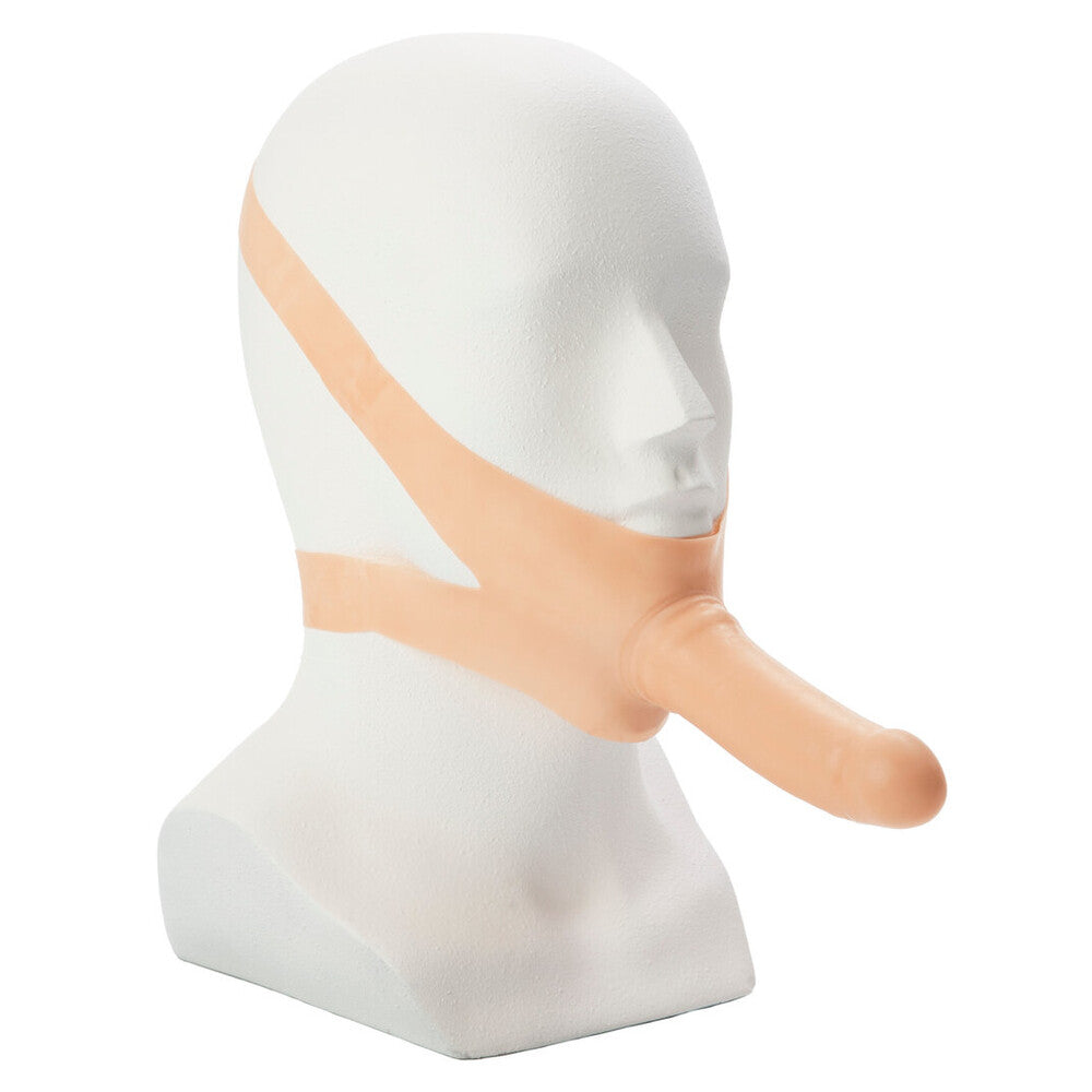 California Exotic Accommodator face strap-on dildo in flesh color, showcasing realistic design and adjustable straps.