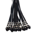 Hidden Desire Masters leather CatoNine whip with braided design and sturdy handle, displayed on a textured surface.