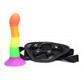 XR Brands Proud Rainbow silicone dildo with harness, showcasing vibrant colors and smooth texture on a white background.